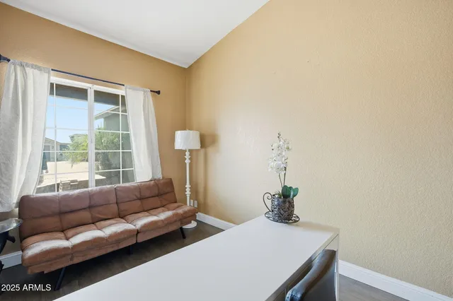 a view of a room with a table and chairs