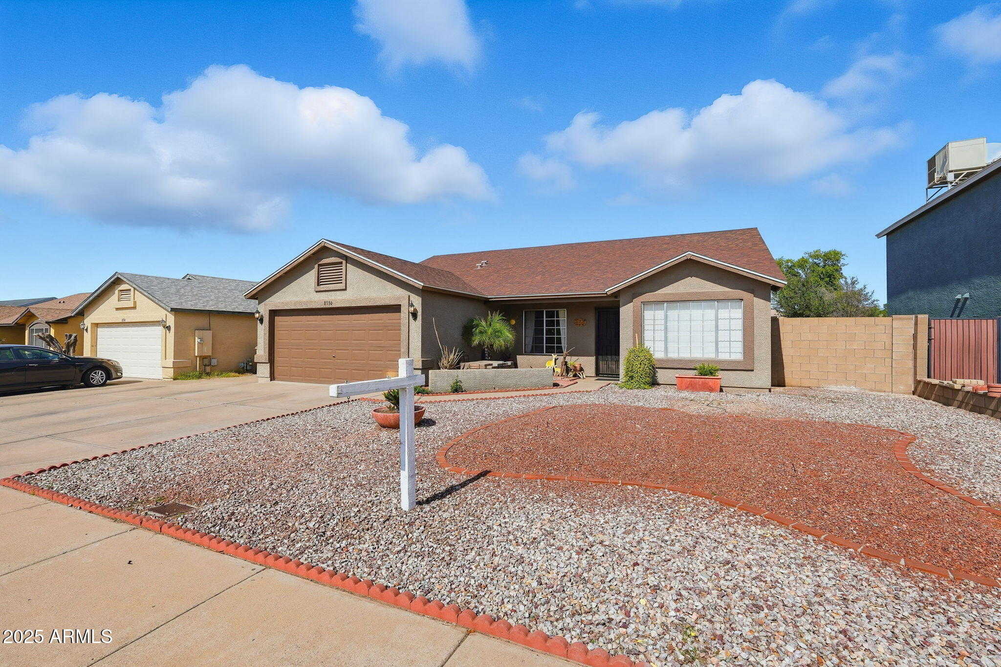 8730 West Ocotillo Road Glendale, AZ 85305 - Photo 2 of 58 a front view of a house with a yard and garage