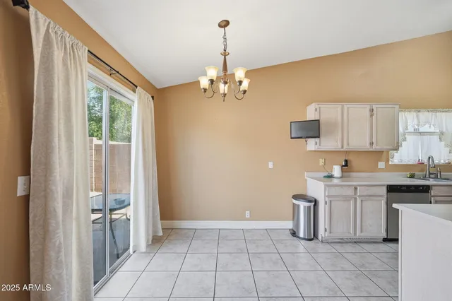 a view of a dining room with furniture and chandelier fan