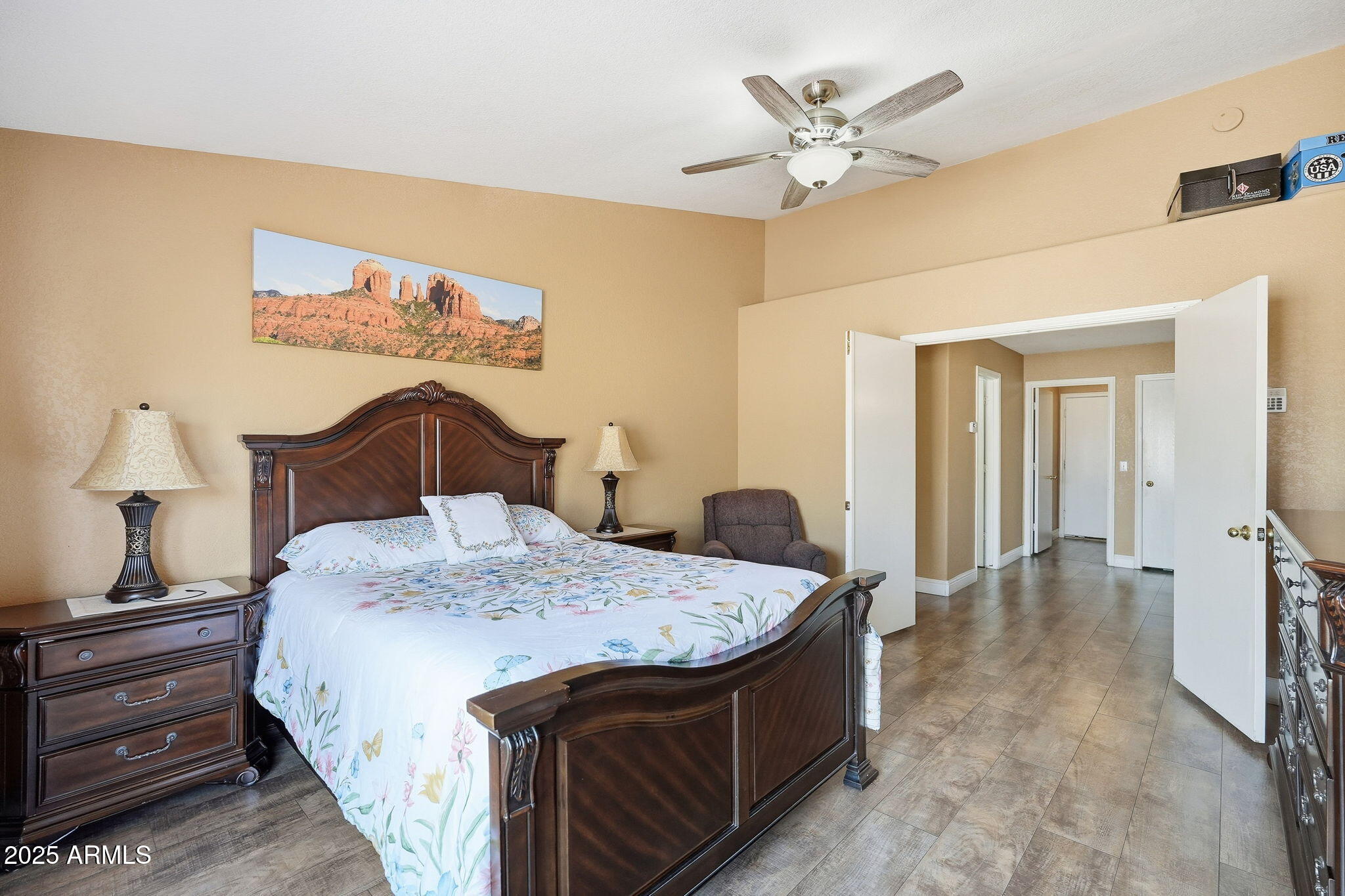 8730 West Ocotillo Road Glendale, AZ 85305 - Photo 30 of 58 a bedroom with a bed and a chandelier