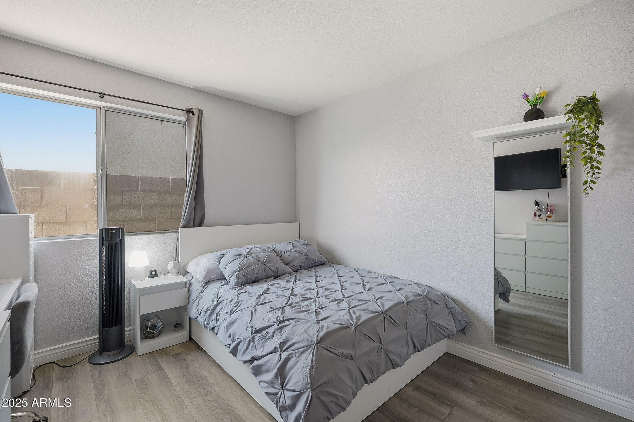 8730 West Ocotillo Road Glendale, AZ 85305 - Photo 35 of 58 a bedroom with a bed and a potted plant