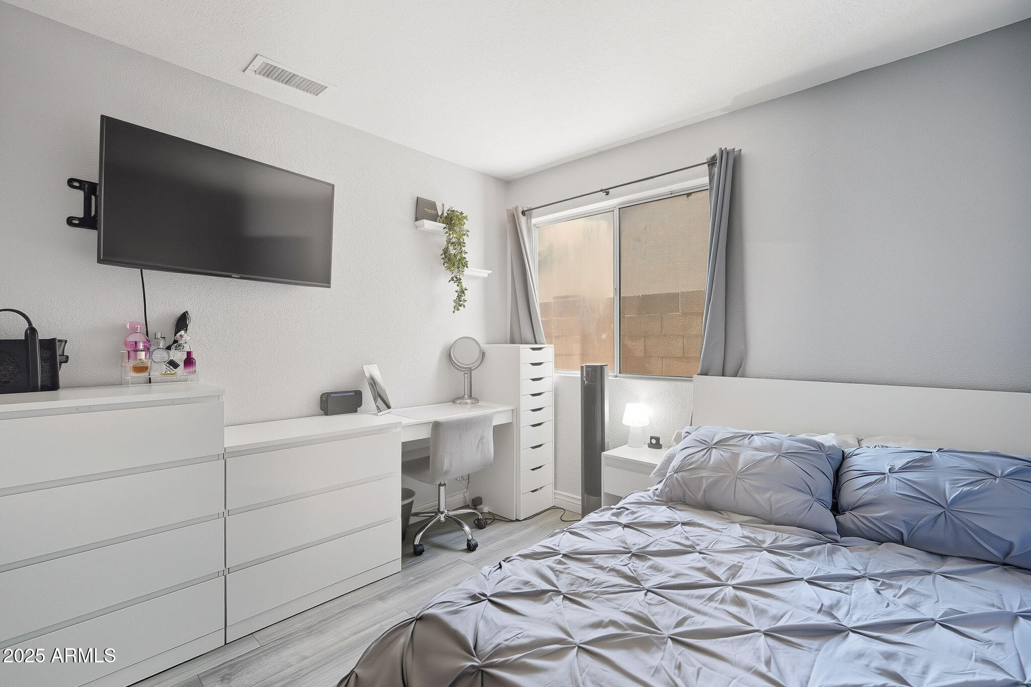 8730 West Ocotillo Road Glendale, AZ 85305 - Photo 36 of 58 a spacious bedroom with a bed and a flat screen tv