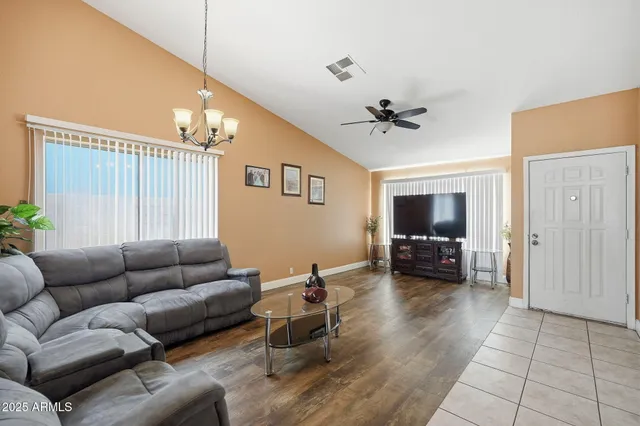 a living room with furniture ceiling fan and a window
