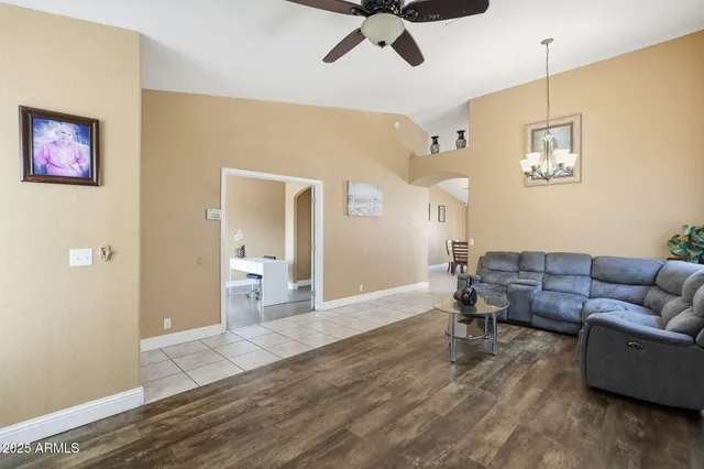 a living room with furniture and a wooden floor