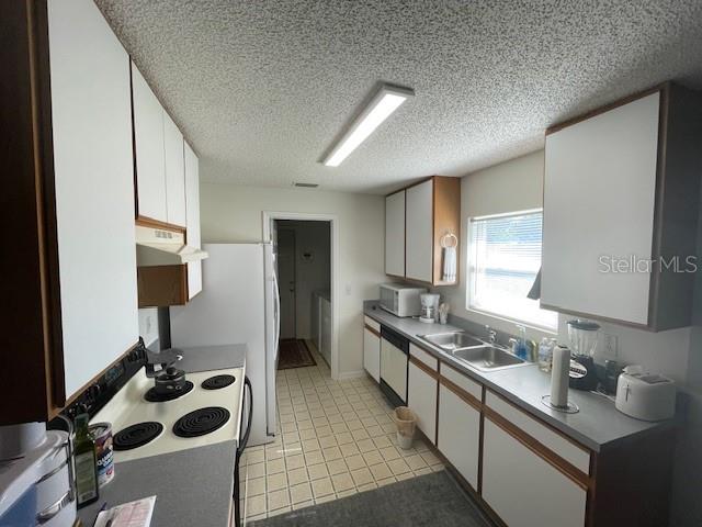 51 Foster Lane Palm Coast, FL 32137 - Photo 6 of 12 a kitchen with a sink appliances and cabinets