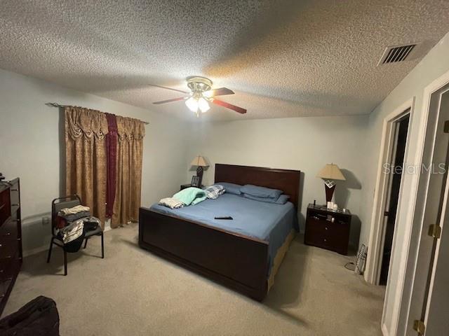 51 Foster Lane Palm Coast, FL 32137 - Photo 7 of 12 a bedroom with a bed and a chandelier