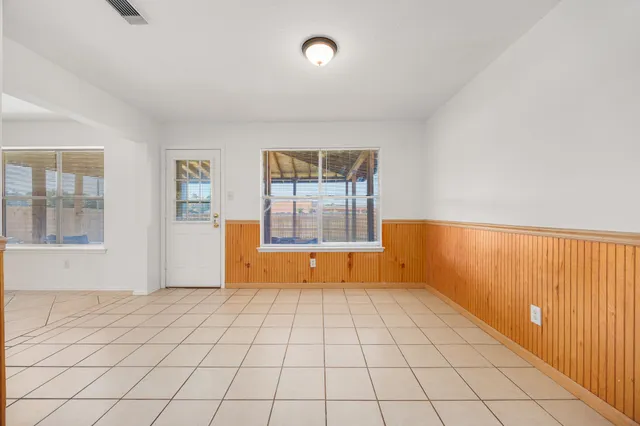 a large kitchen with stainless steel appliances granite countertop a stove a sink and a microwave