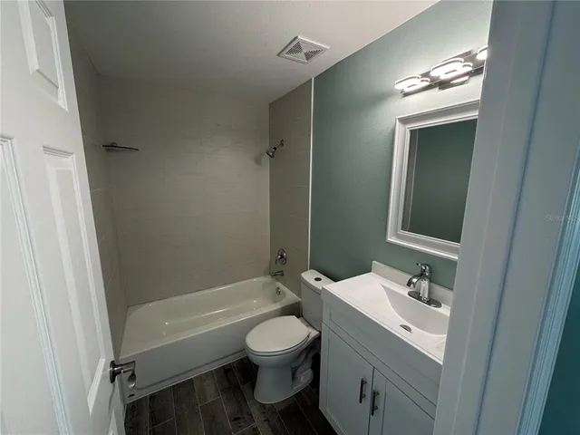 a bathroom with a toilet sink and a mirror