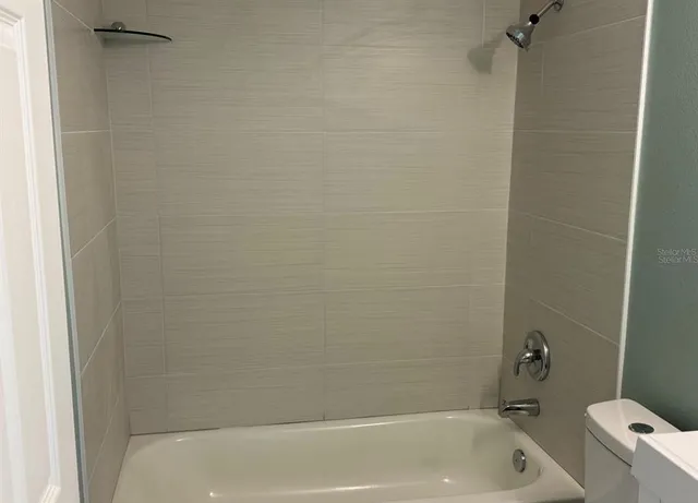 a bathroom with a bathtub and a toilet