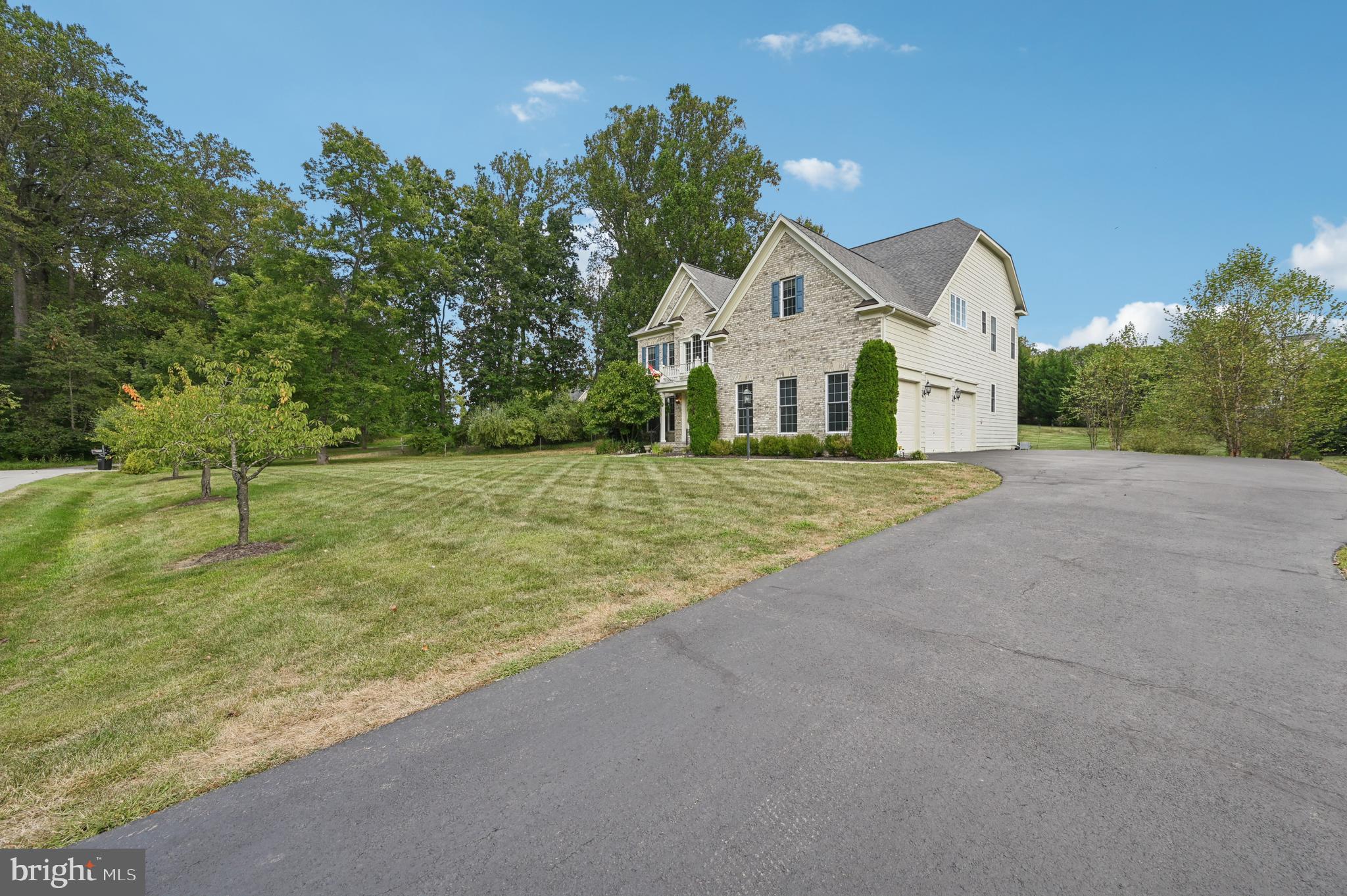 4884 Castlebridge Road Ellicott City, MD 21042 - Photo 2 of 130 a view of a house with a yard and potted plants