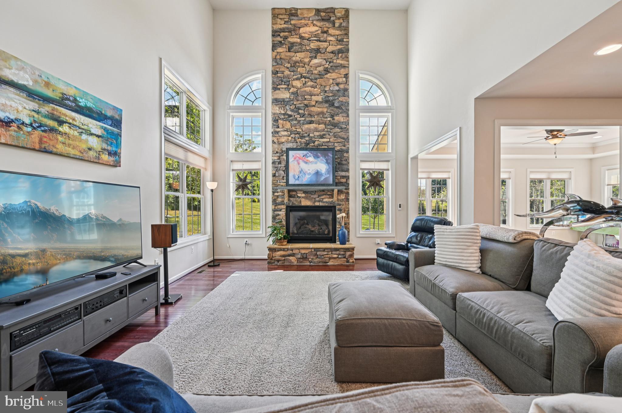 4884 Castlebridge Road Ellicott City, MD 21042 - Photo 21 of 130 a living room with furniture fireplace and flat screen tv