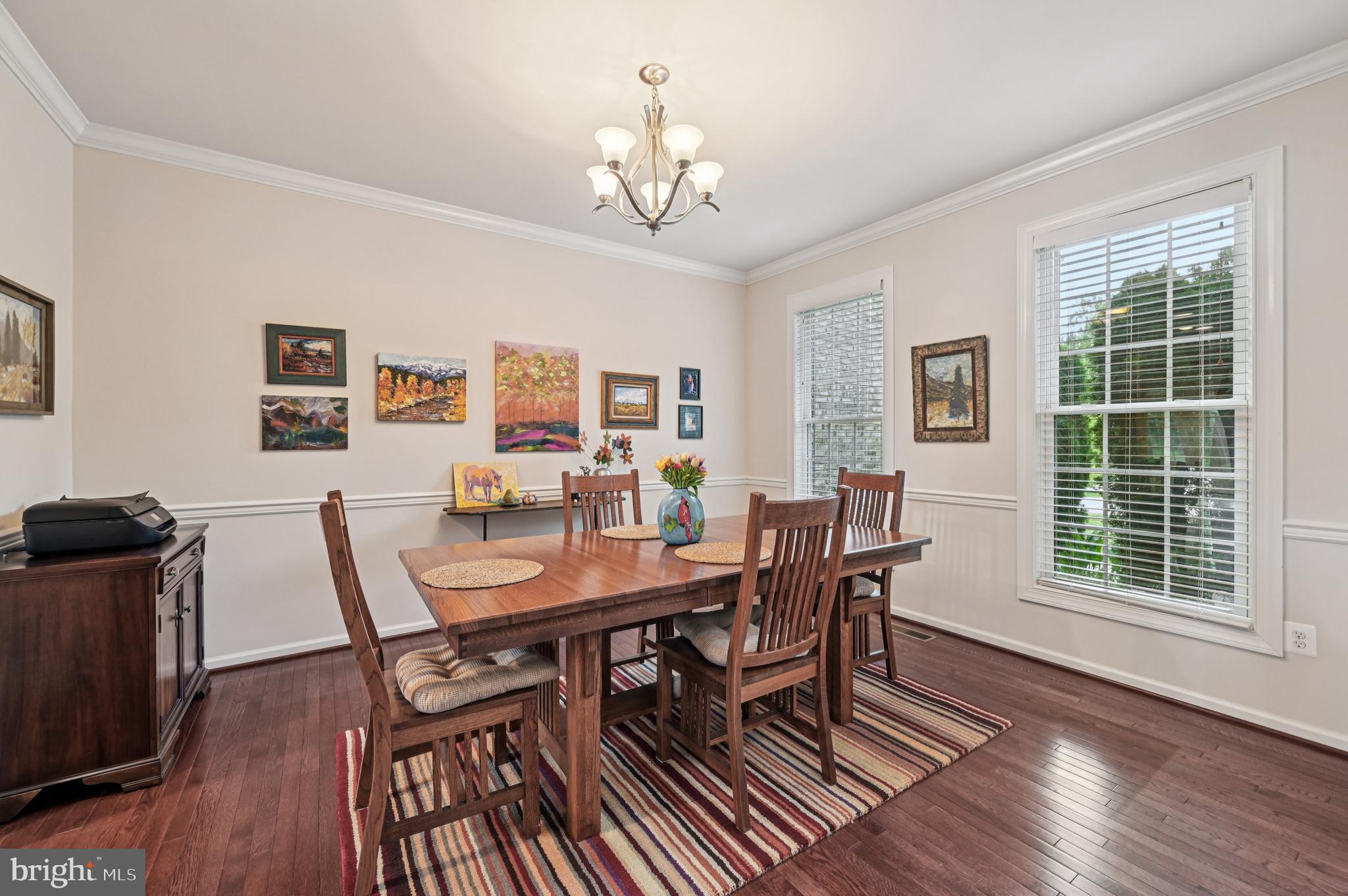 4884 Castlebridge Road Ellicott City, MD 21042 - Photo 25 of 130 a view of a dining room with furniture a chandelier and wooden floor