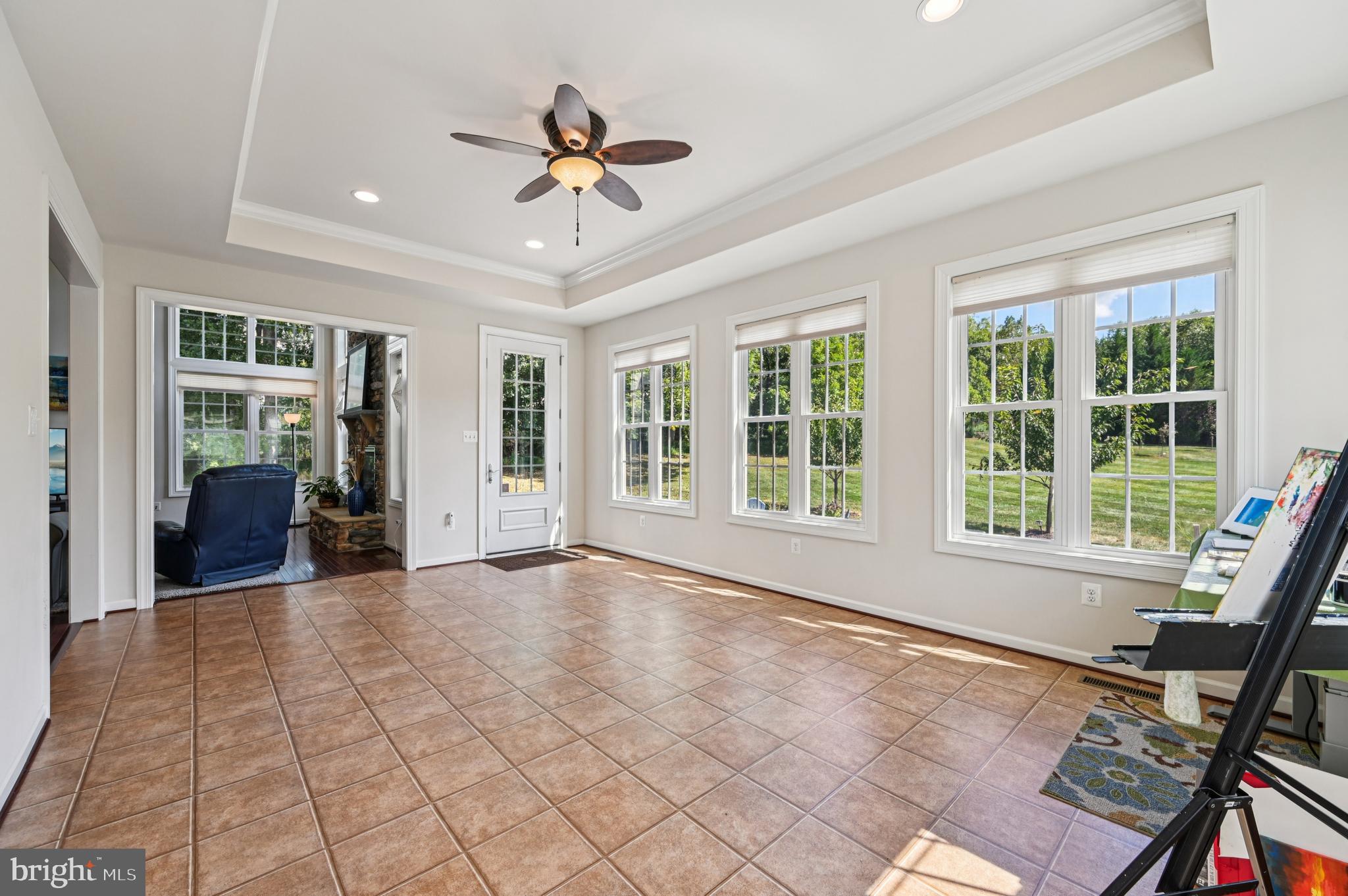 4884 Castlebridge Road Ellicott City, MD 21042 - Photo 40 of 130 a view of an empty room with a window and wooden floor