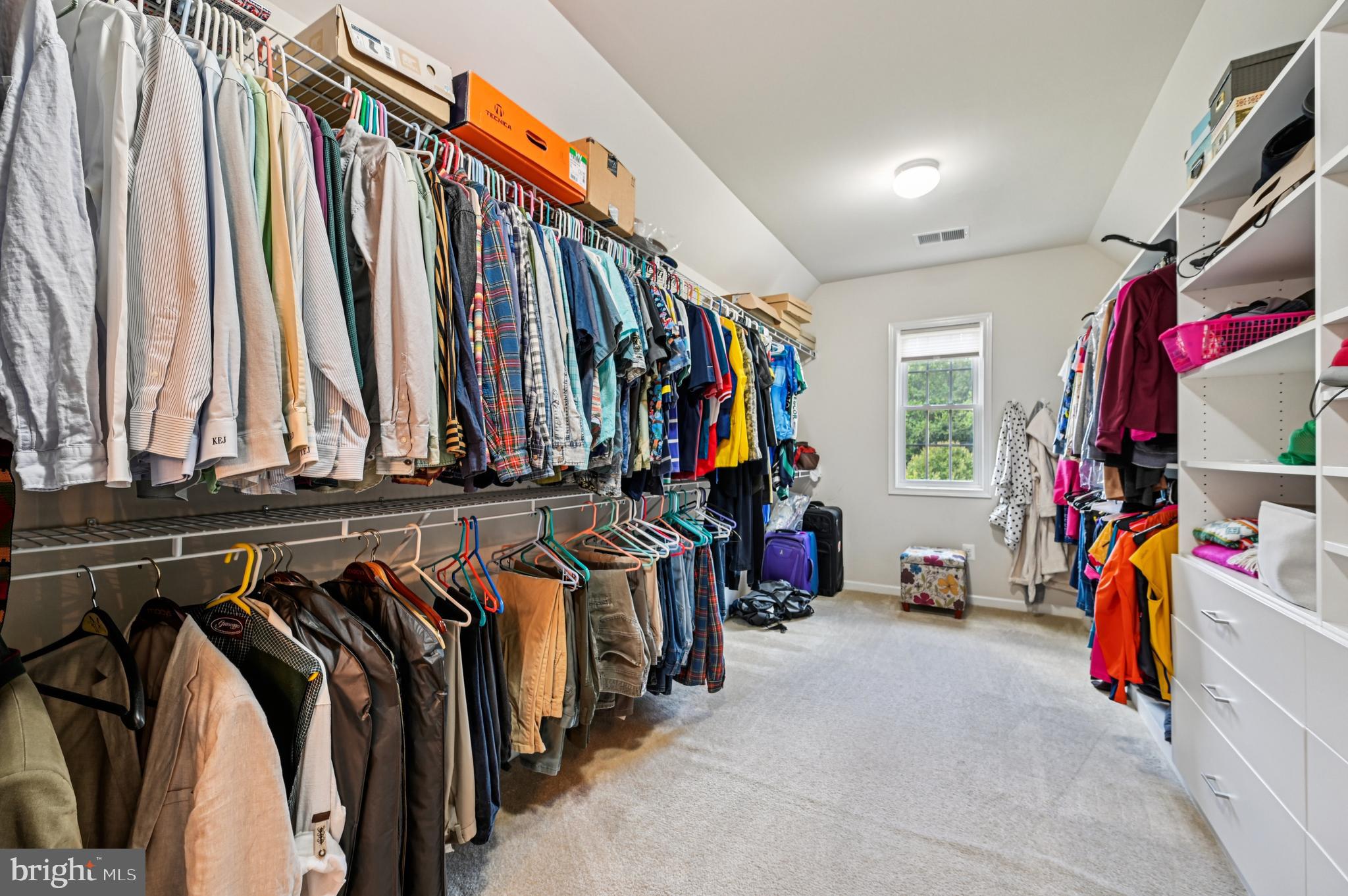 4884 Castlebridge Road Ellicott City, MD 21042 - Photo 74 of 130 a view of walk in closet with clothes and shoes