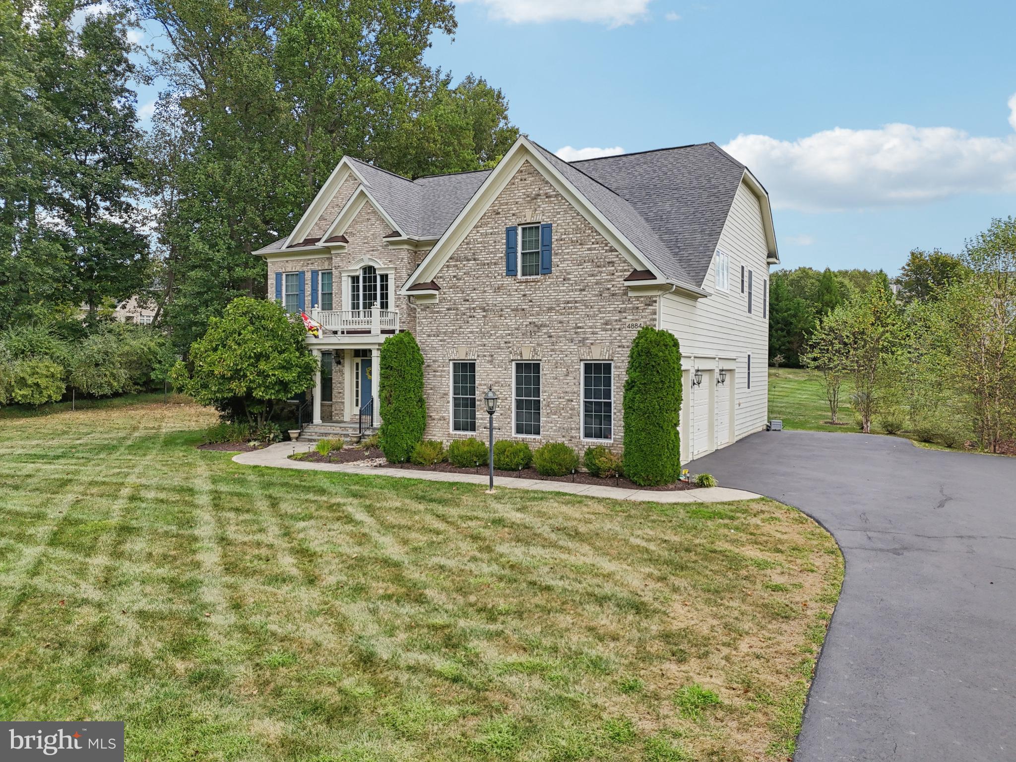 4884 Castlebridge Road Ellicott City, MD 21042 - Photo 99 of 130 a view of a white house with a yard and plants