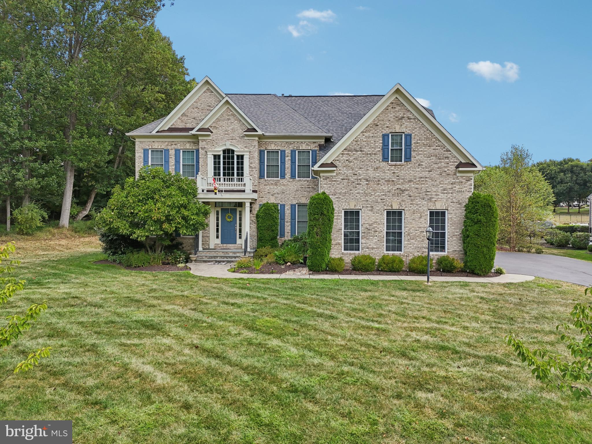 4884 Castlebridge Road Ellicott City, MD 21042 - Photo 100 of 130 a front view of a house with a yard and garage