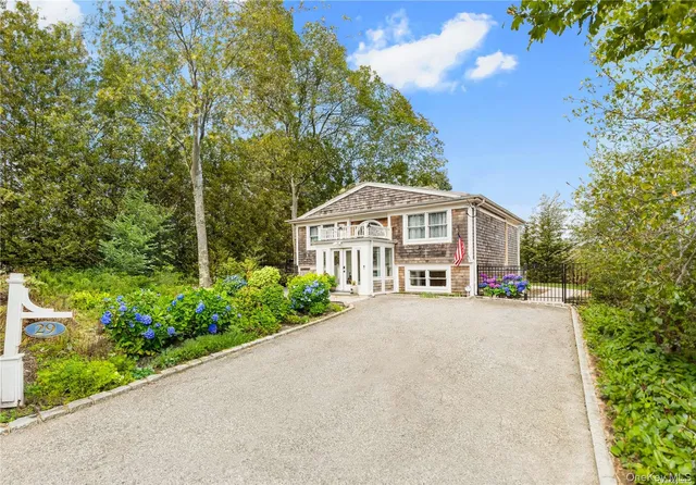 a view of a house with a yard and potted plants