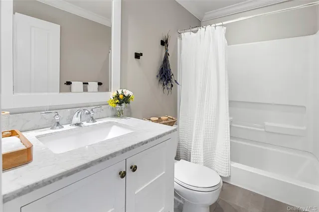 a bedroom with a bed lamp and a window