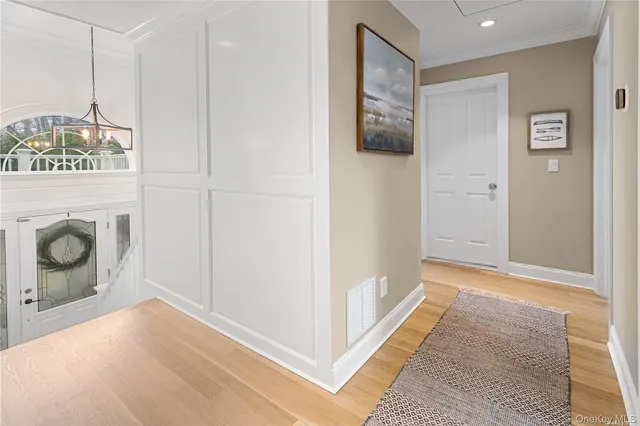 a living room with furniture a flat screen tv and a wooden floor