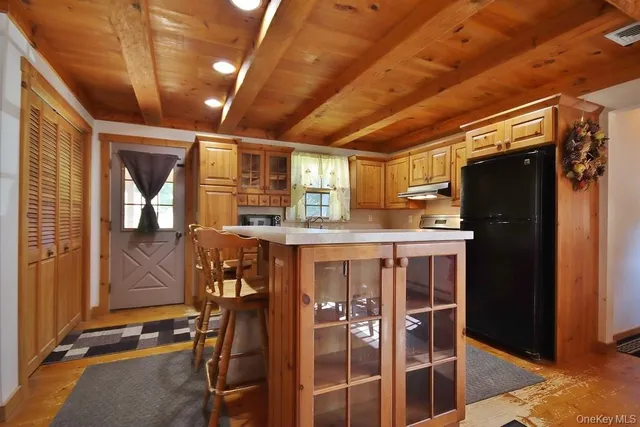 a view of a dining room with furniture and a chandelier