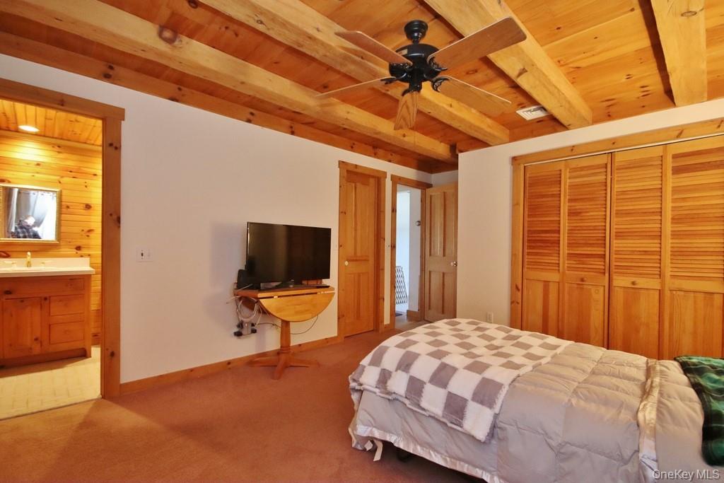 138 Round Hill Road Walden, NY 12586 - Photo 14 of 48 a bedroom with a bed and wooden floor