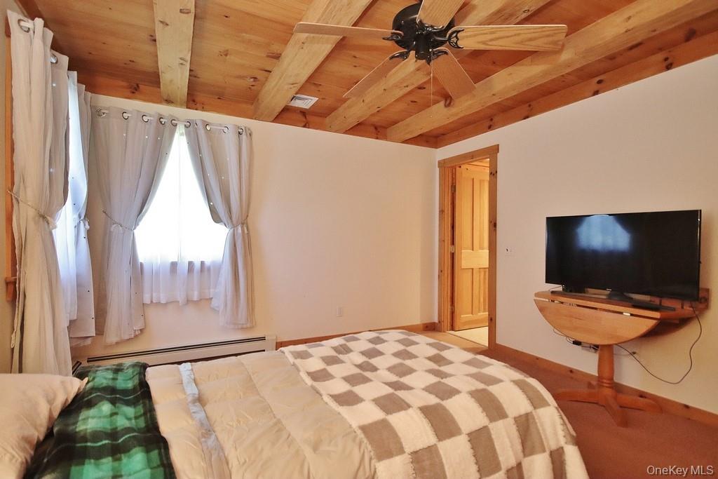 138 Round Hill Road Walden, NY 12586 - Photo 17 of 48 a bedroom with a bed and a flat screen tv