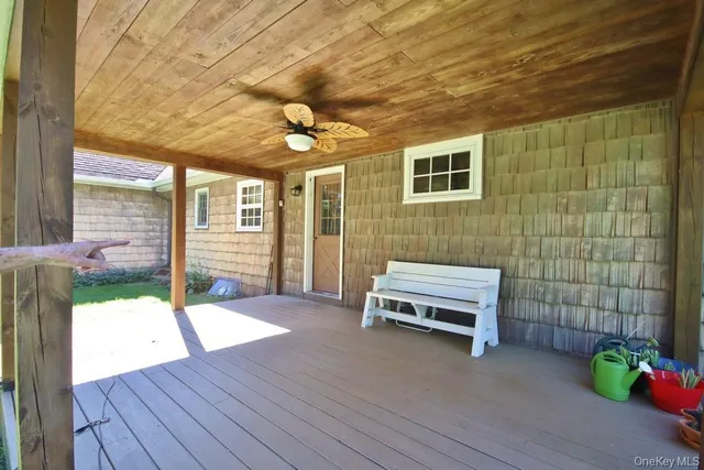 a backyard of a house with barbeque oven table and chairs