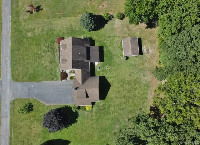 an aerial view of a house with a yard