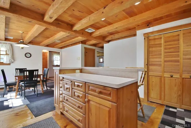 a view of a kitchen with stainless steel appliances granite countertop furniture stove top oven and cabinets