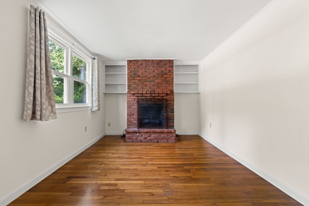 52 Middle Road Merrimac, MA 01860 - Photo 11 of 24 a view of an empty room with wooden floor and a window
