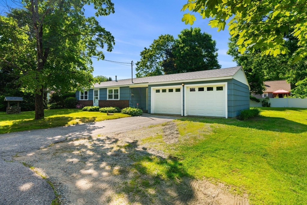 52 Middle Road Merrimac, MA 01860 - Photo 3 of 24 a view of swimming pool with umbrella and trees in the background