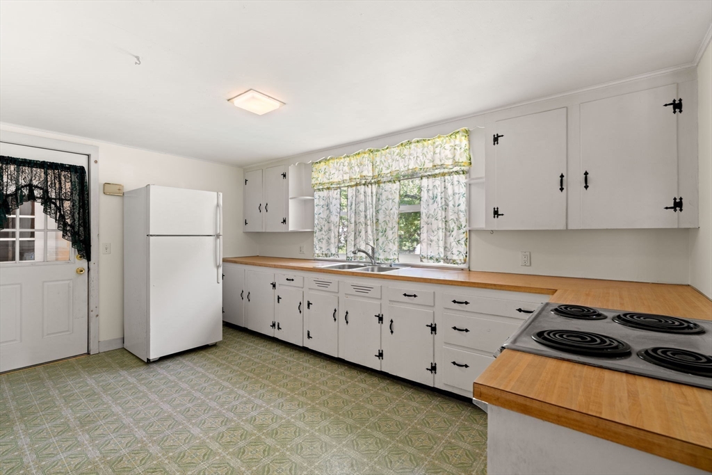 52 Middle Road Merrimac, MA 01860 - Photo 5 of 24 a kitchen with granite countertop white cabinets and white appliances