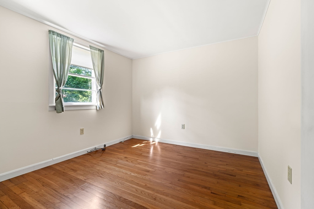 52 Middle Road Merrimac, MA 01860 - Photo 9 of 24 an empty room with wooden floor and window