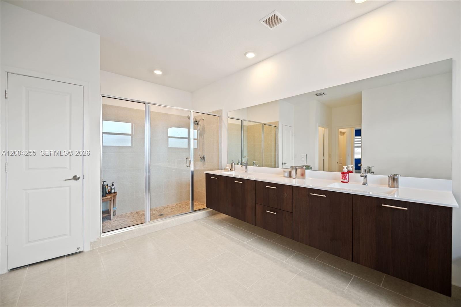 4366 Southwest 174th Avenue Miramar, FL 33029 - Photo 14 of 42 a large bathroom with a large mirror vanity and shower