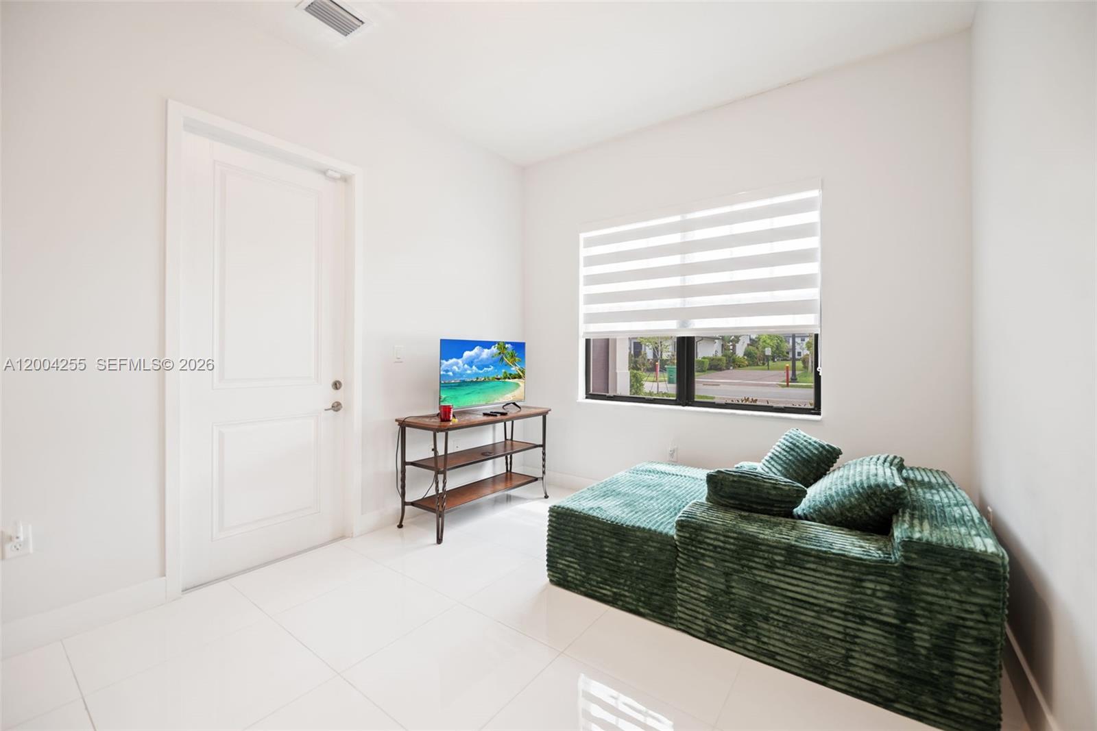 4366 Southwest 174th Avenue Miramar, FL 33029 - Photo 27 of 42 a living room with furniture and a window