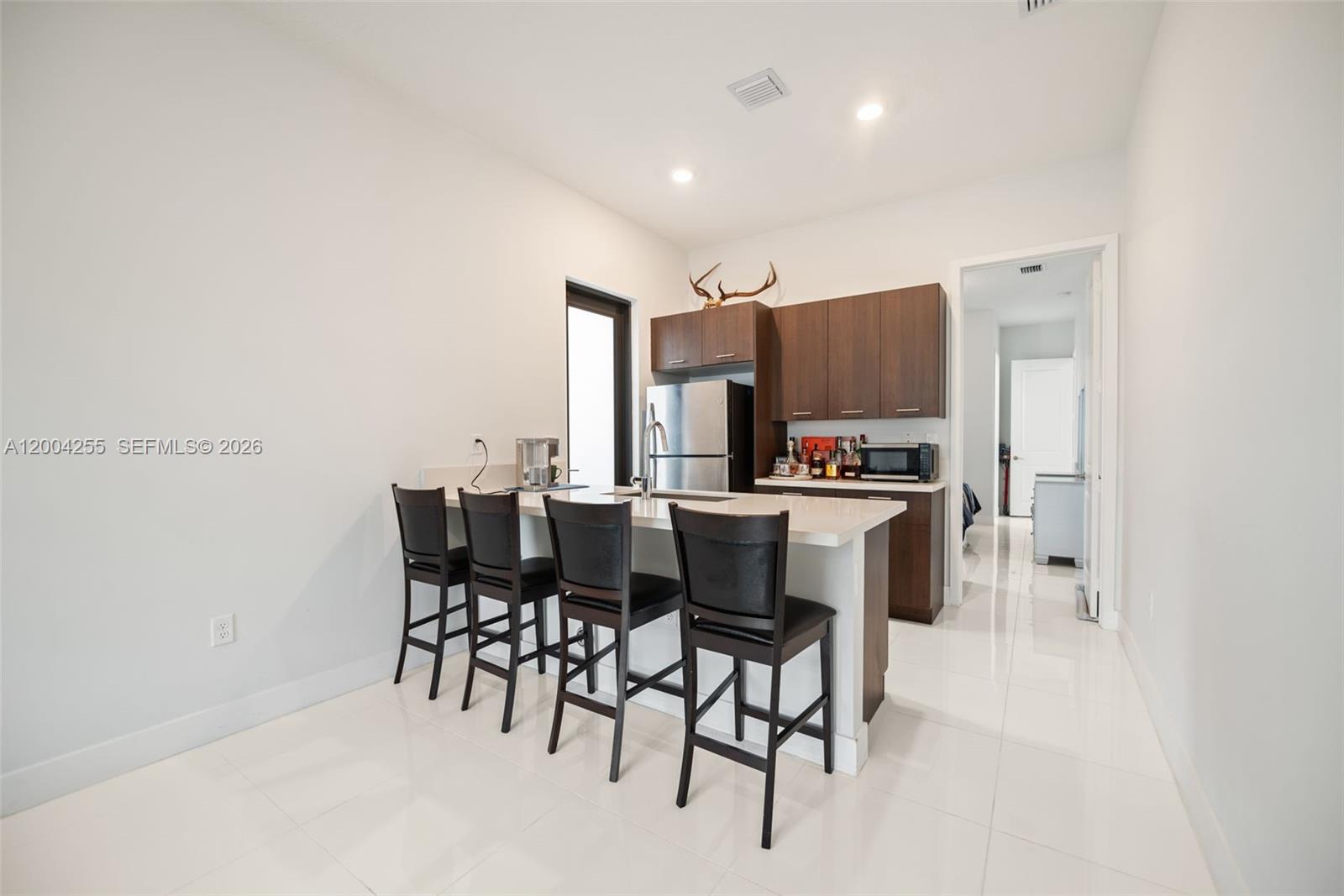 4366 Southwest 174th Avenue Miramar, FL 33029 - Photo 30 of 42 a open kitchen with dining table and chairs