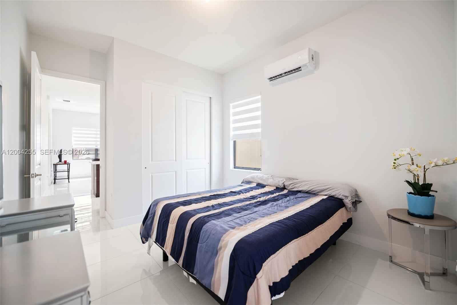 4366 Southwest 174th Avenue Miramar, FL 33029 - Photo 32 of 42 a bedroom with double bed and a potted plant