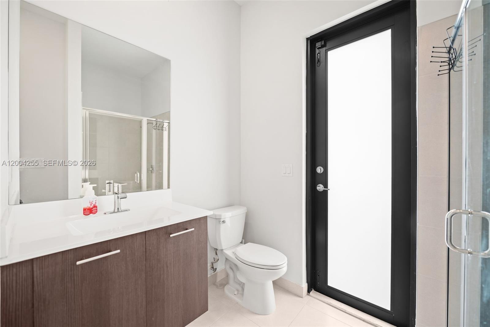 4366 Southwest 174th Avenue Miramar, FL 33029 - Photo 33 of 42 a bathroom with a sink vanity mirror and toilet