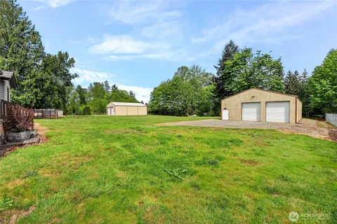a backyard of a house with lots of green space and plants