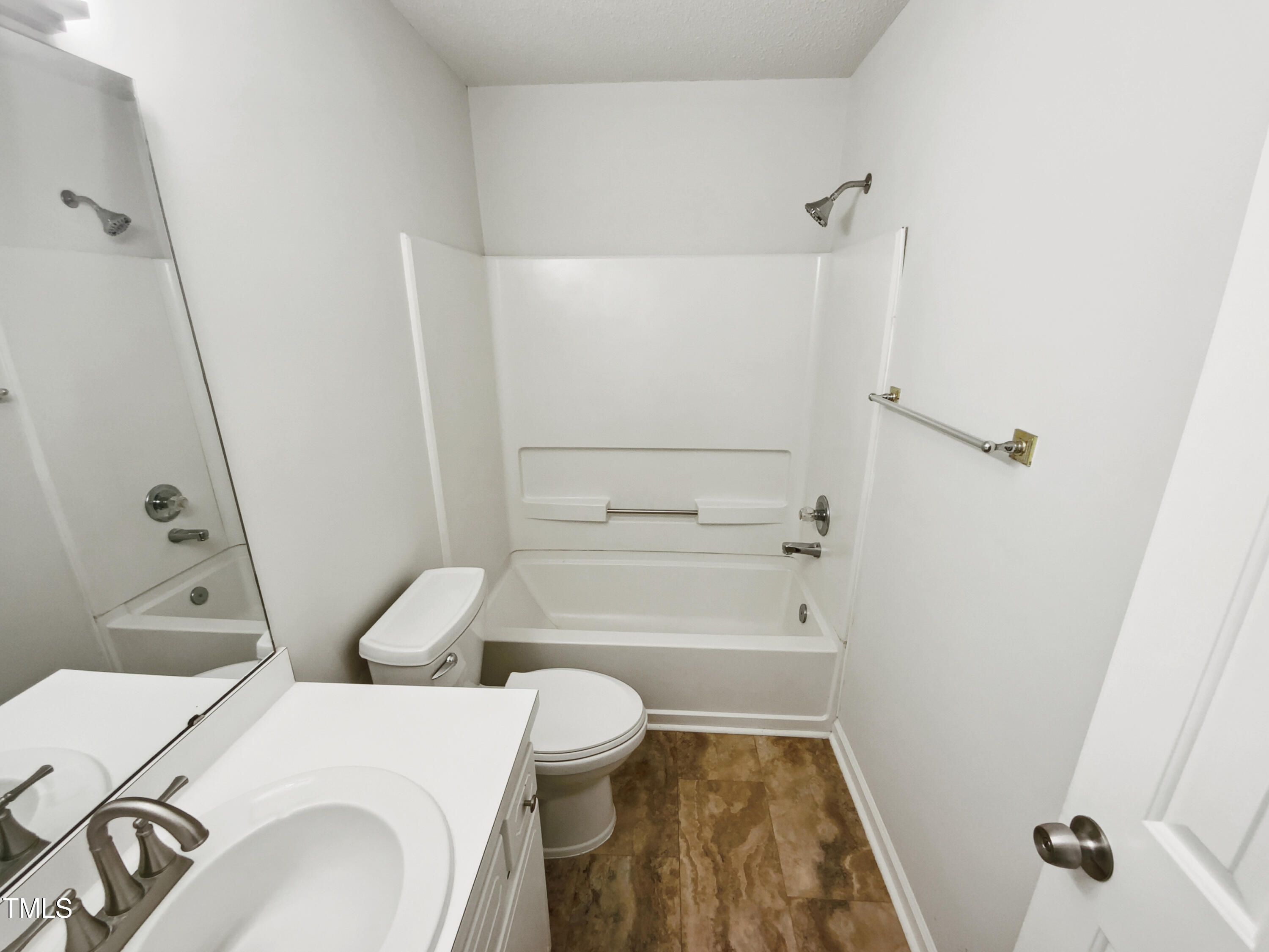 4205 Rockside Hills Drive Raleigh, NC 27603 - Photo 18 of 19 a bathroom with a sink and a mirror