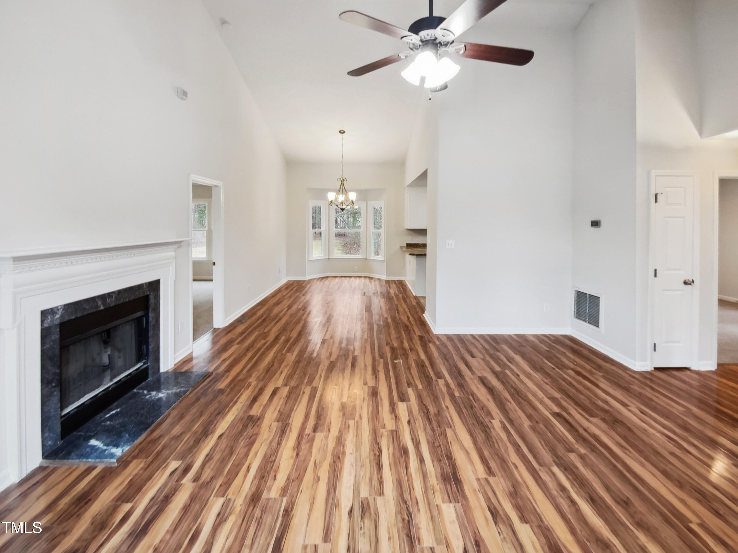4205 Rockside Hills Drive Raleigh, NC 27603 - Photo 3 of 19 a view of a livingroom with wooden floor and a fireplace