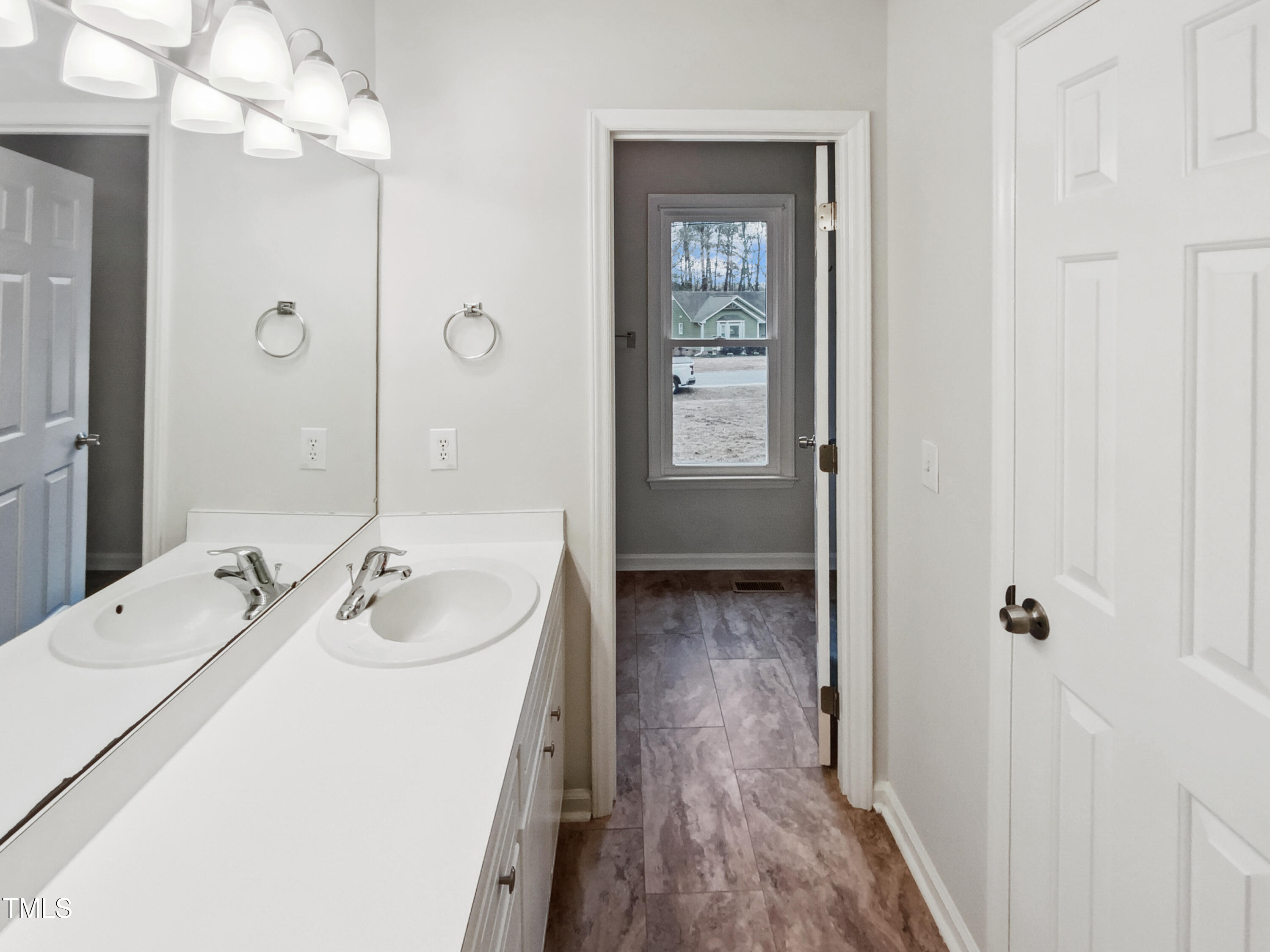 4205 Rockside Hills Drive Raleigh, NC 27603 - Photo 7 of 19 a bathroom with a sink a mirror and shower