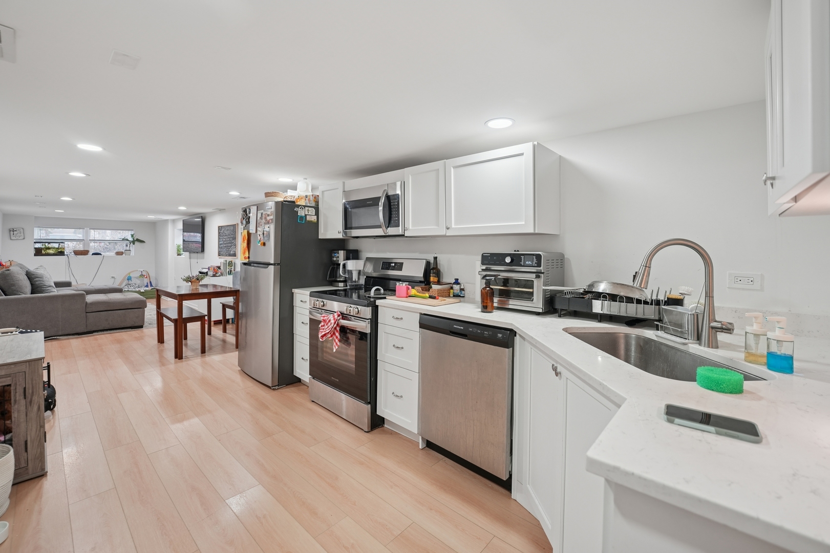 4954 West Byron Street Chicago, IL 60641 - Photo 13 of 33 a kitchen with stainless steel appliances granite countertop a refrigerator sink and white cabinets