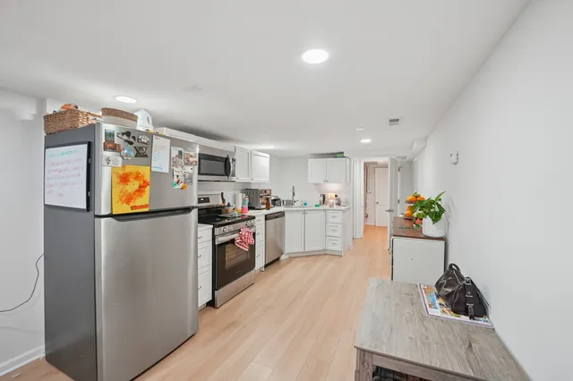 a view of kitchen with furniture and wooden floor