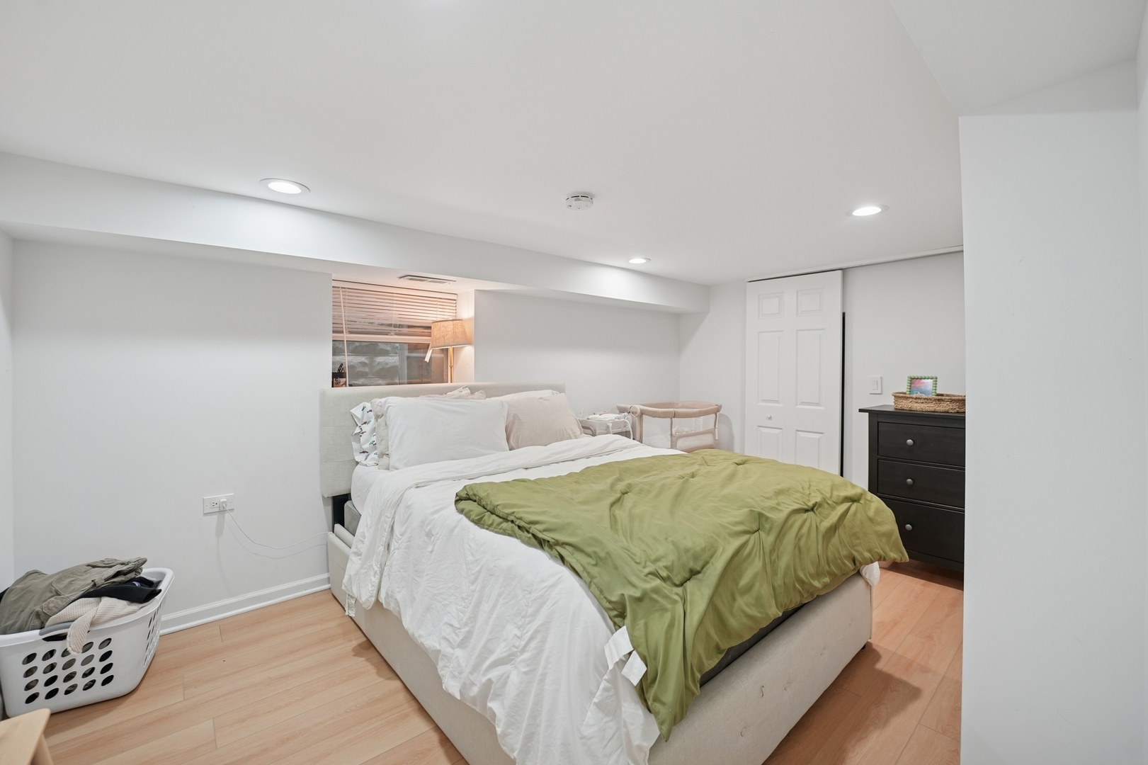 4954 West Byron Street Chicago, IL 60641 - Photo 18 of 33 a spacious bedroom with a bed and a lamp