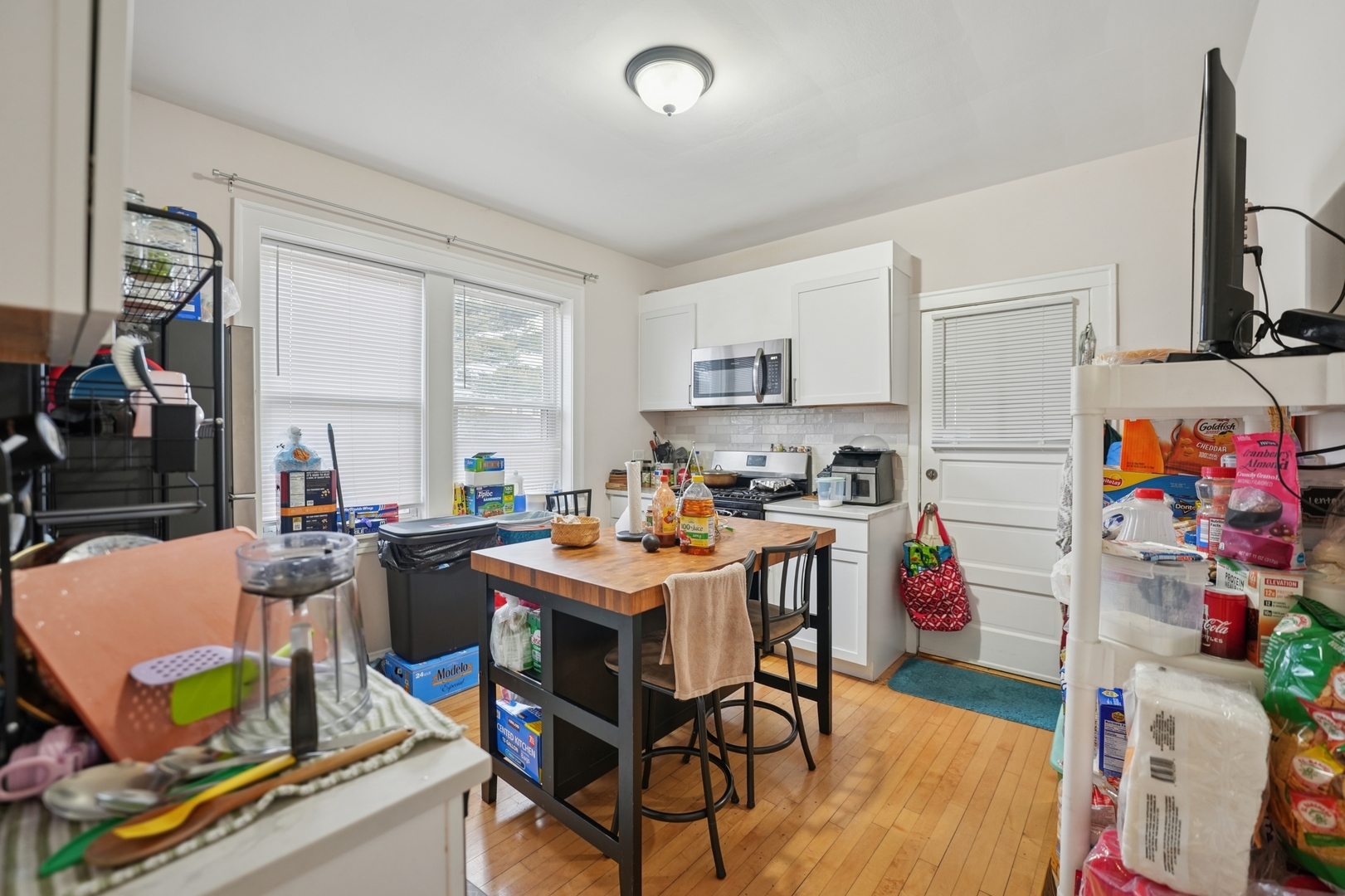 4954 West Byron Street Chicago, IL 60641 - Photo 18 of 25 a view of a dining room with furniture a rug and a window