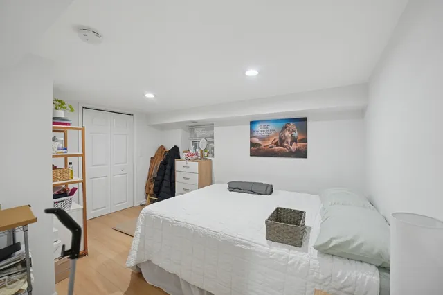 a bedroom with a large bed and a book shelf