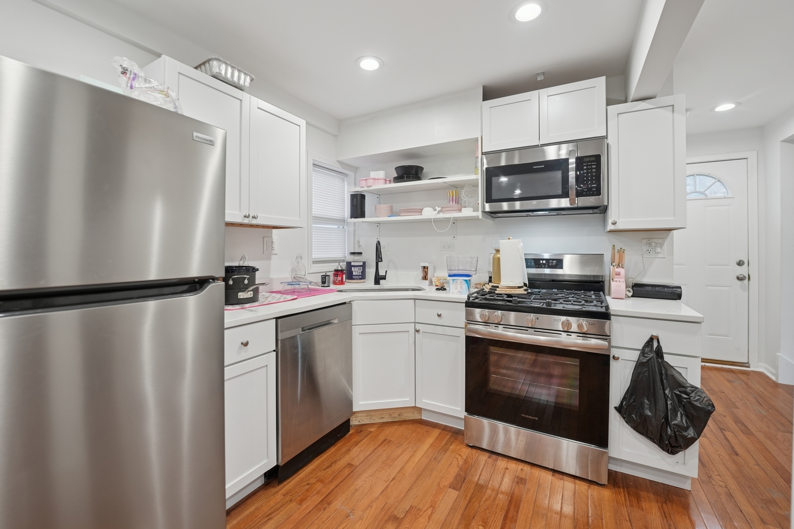 4954 West Byron Street Chicago, IL 60641 - Photo 21 of 25 a kitchen with stainless steel appliances a refrigerator stove and white cabinets