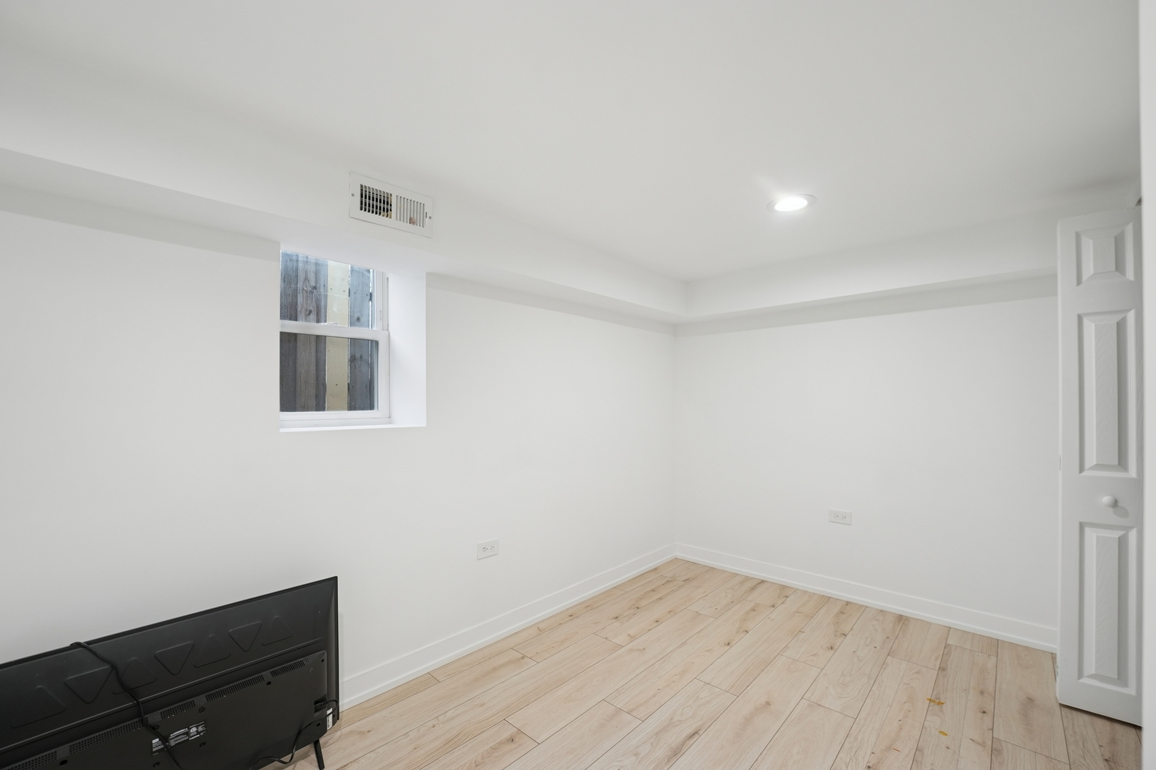 4954 West Byron Street Chicago, IL 60641 - Photo 25 of 25 an empty room with wooden floor and windows