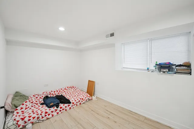 a bedroom with a bed and a lamp